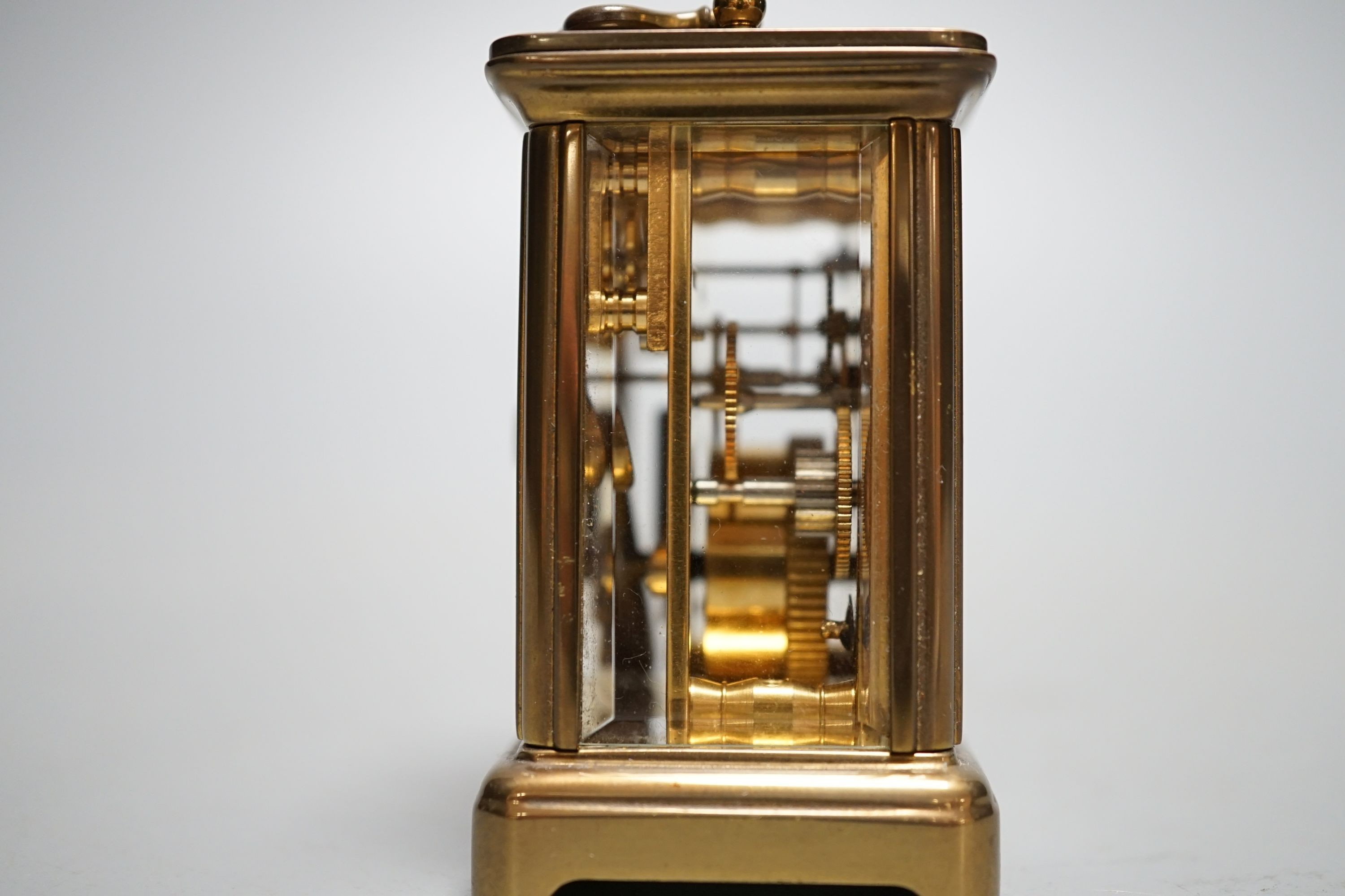 A Mathew Norman miniature brass carriage timepiece, 6cms high.